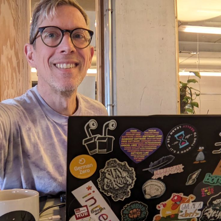 Portrait: Ingo Steinke, Frontend Web Developer, Freelancer, working at his laptop at Impact Hub Berlin